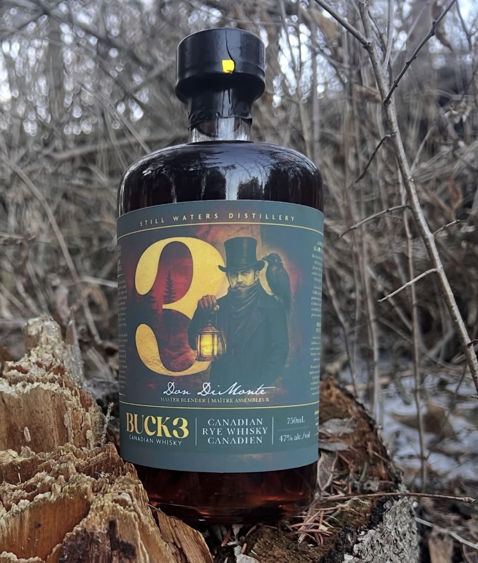 Bottle of Buck 3 Canadian Rye Whisky photographed in an Ontario woodland